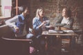 students girls sitting in cafe and having funny convers Royalty Free Stock Photo