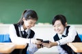 Students girls watching the smart phone in classroom