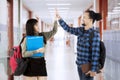 Students give high five in school corridor Royalty Free Stock Photo