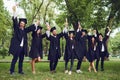 Students graduates with scrolls of diplomas up Royalty Free Stock Photo