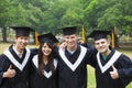 students in graduation gowns on university campus