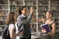 Students greet each other in university library Royalty Free Stock Photo