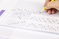 Students hand doing exams quiz test paper at school