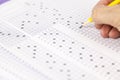 students hand doing exams quiz test paper at school