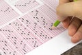 Students hand doing exams quiz test paper