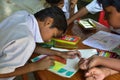 Students hands holding colored pencils painting on art drawing paper Royalty Free Stock Photo