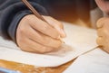 Students hands taking exams, writing examination room with holding pencil on optical form of standardized test with answers and Royalty Free Stock Photo