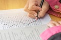 Students hands taking exams, writing examination room with holding pencil on optical form of standardized test with answers and Royalty Free Stock Photo