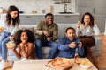 students having fun playing video games during home party indoors Royalty Free Stock Photo