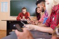 Students High School Group With Professor Using Cell Smart Phones Hands Close Up, Young People Sit Desk University