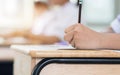 Students holding pen in hands taking exams, writing examination Royalty Free Stock Photo