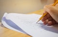 Students holding pen in hands taking exams, writing examination Royalty Free Stock Photo