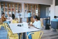 Students, laptop and modern library for education, learning and study on school campus. Men, women or people with Royalty Free Stock Photo