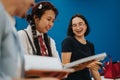 Students laughing and studying together in a bright classroom Royalty Free Stock Photo