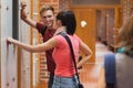 Students leaning against locker flirting Royalty Free Stock Photo