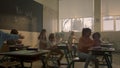 Students learning in classroom . Schoolboys and schoolgirls sitting at desks Royalty Free Stock Photo