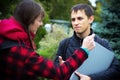 Students learning concept - boy and girl talking about examination passed Royalty Free Stock Photo