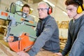 Students learning how to use large circular saw