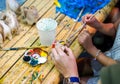 students learning paint on wood animal doll in the art classroom