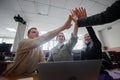 Students and lecturer give a high five in the university classroom. Royalty Free Stock Photo