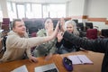 Students and lecturer give a high five in the university classroom. Royalty Free Stock Photo