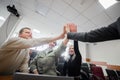 Students and lecturer give a high five in the university classroom. Royalty Free Stock Photo