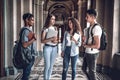 Students life. Four beautiful students chatting each other in the university Royalty Free Stock Photo