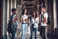 Students life. Four confident students negotiate their research in the university Royalty Free Stock Photo