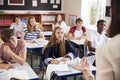 Students Listening To Female Teacher In Classroom Royalty Free Stock Photo