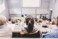 Students listening to lecture and making notes. Professor giving presentation in lecture hall at university Royalty Free Stock Photo