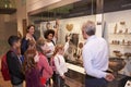 Students Looking At Artifacts In Case On Trip To Museum