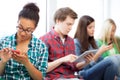 Students looking into devices at school