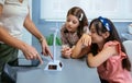 Students looking solar windmill while teacher explaining in ecology classroom