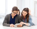 Students looking at tablet pc in lecture at school Royalty Free Stock Photo