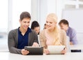 Students looking at tablet pc in lecture at school Royalty Free Stock Photo