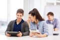 Students looking at tablet pc in lecture at school Royalty Free Stock Photo