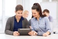 Students looking at tablet pc in lecture at school Royalty Free Stock Photo