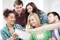 Students looking at tablet pc at school Royalty Free Stock Photo