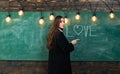 Students love. Portrait of girl teenager in love. Young cute teenage girl in classroom at blackboard. Young attractive Royalty Free Stock Photo