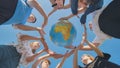 Students make a circle around the globe of the world. The concept of world peace. Royalty Free Stock Photo