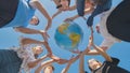 Students make a circle around the globe of the world. The concept of world peace. Royalty Free Stock Photo