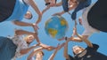 Students make a circle around the globe of the world. The concept of world peace. Royalty Free Stock Photo