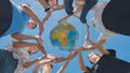 Students make a circle around the globe of the world. The concept of world peace. Royalty Free Stock Photo