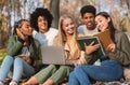 Students making group project, studying together at park Royalty Free Stock Photo