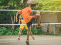 Students playing traditional asian sport game sepak takraw