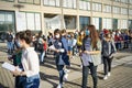 Students queuing at the school entrance wearing mask face