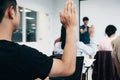 Students raising hands in college lecture room. Royalty Free Stock Photo
