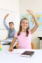 Students raising their hands in class Royalty Free Stock Photo