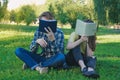 Students reading books. Teenagers hiding faces behing books Royalty Free Stock Photo