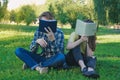 Students reading books. Teenagers hiding faces behing books